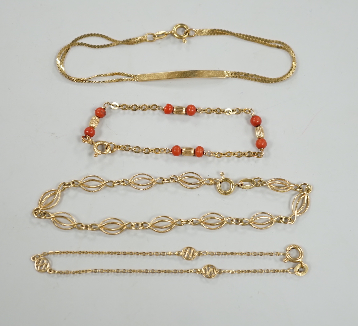 Four assorted 20th century 750 yellow metal bracelets, including child's with coral beads, 13cm